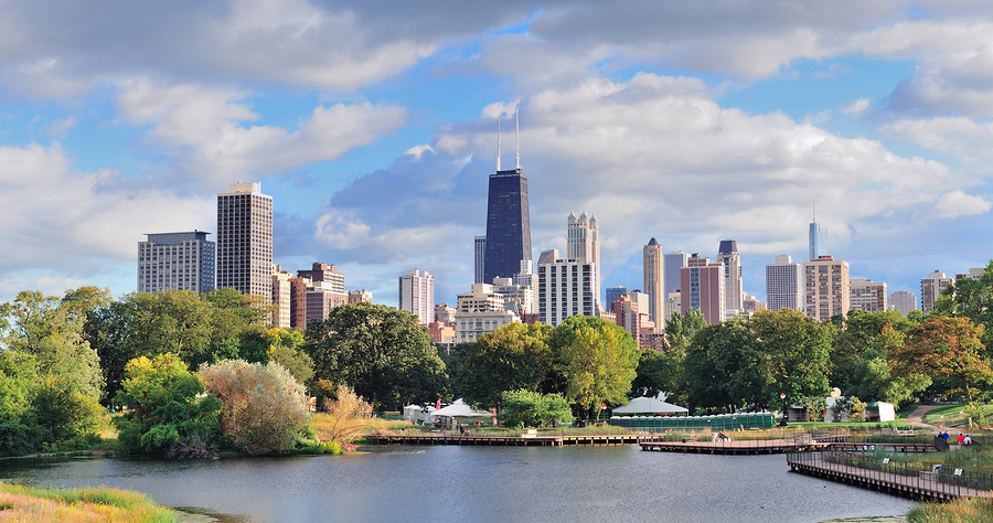 Chicago skyline with skyscrapers viewed from Lincoln Park over lake.