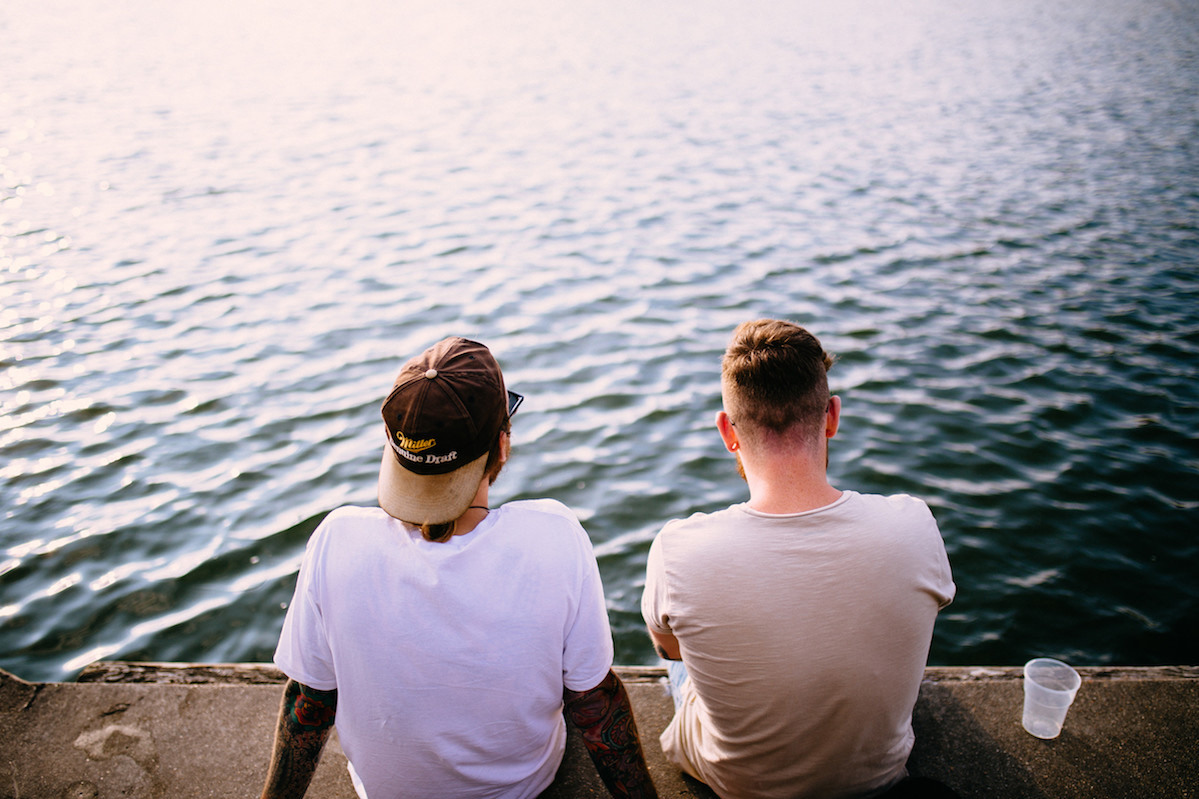 Two Millennials sitting by the water