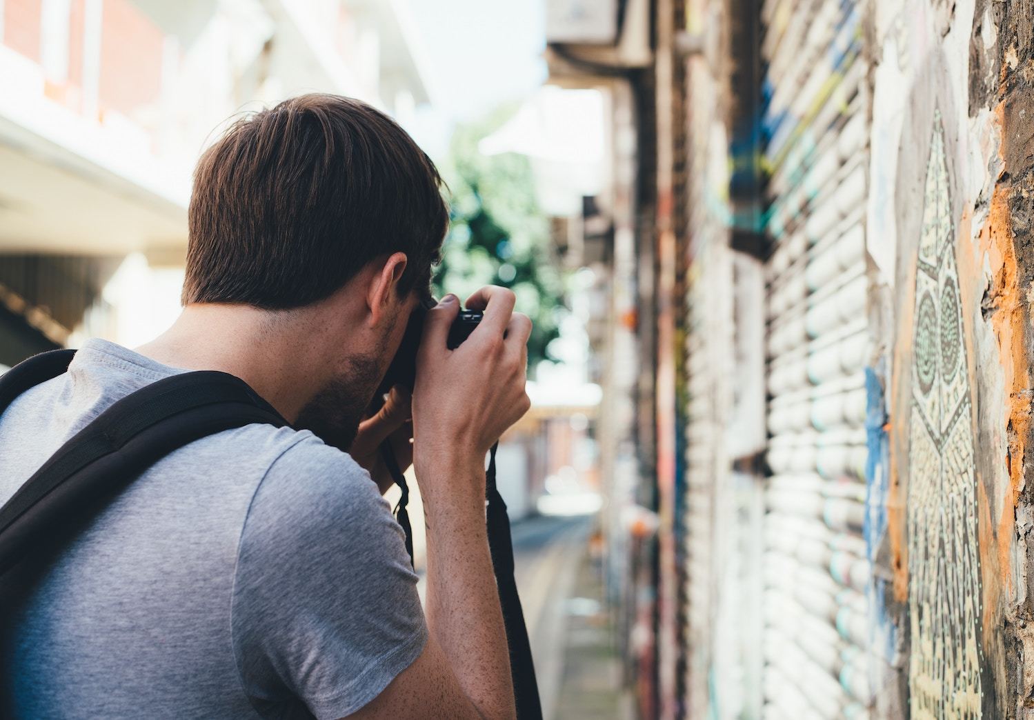 Man takes photo of street art