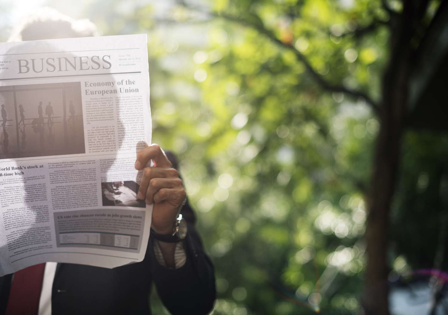 Reading a newspaper outdoors