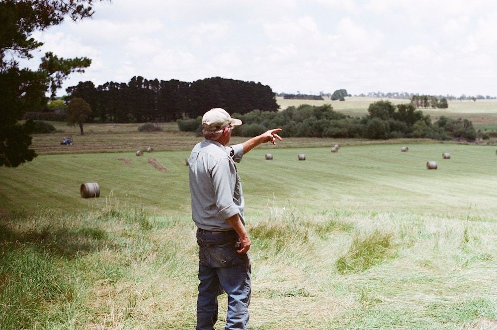 A farmer standing above fields