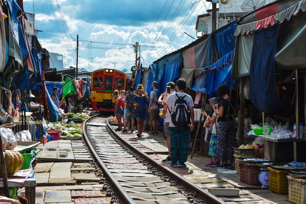 A market along a train track in Thailand