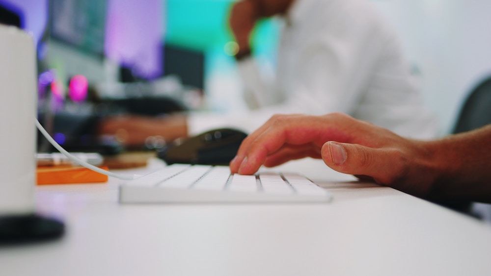 A closeup of a hand on a keyboard