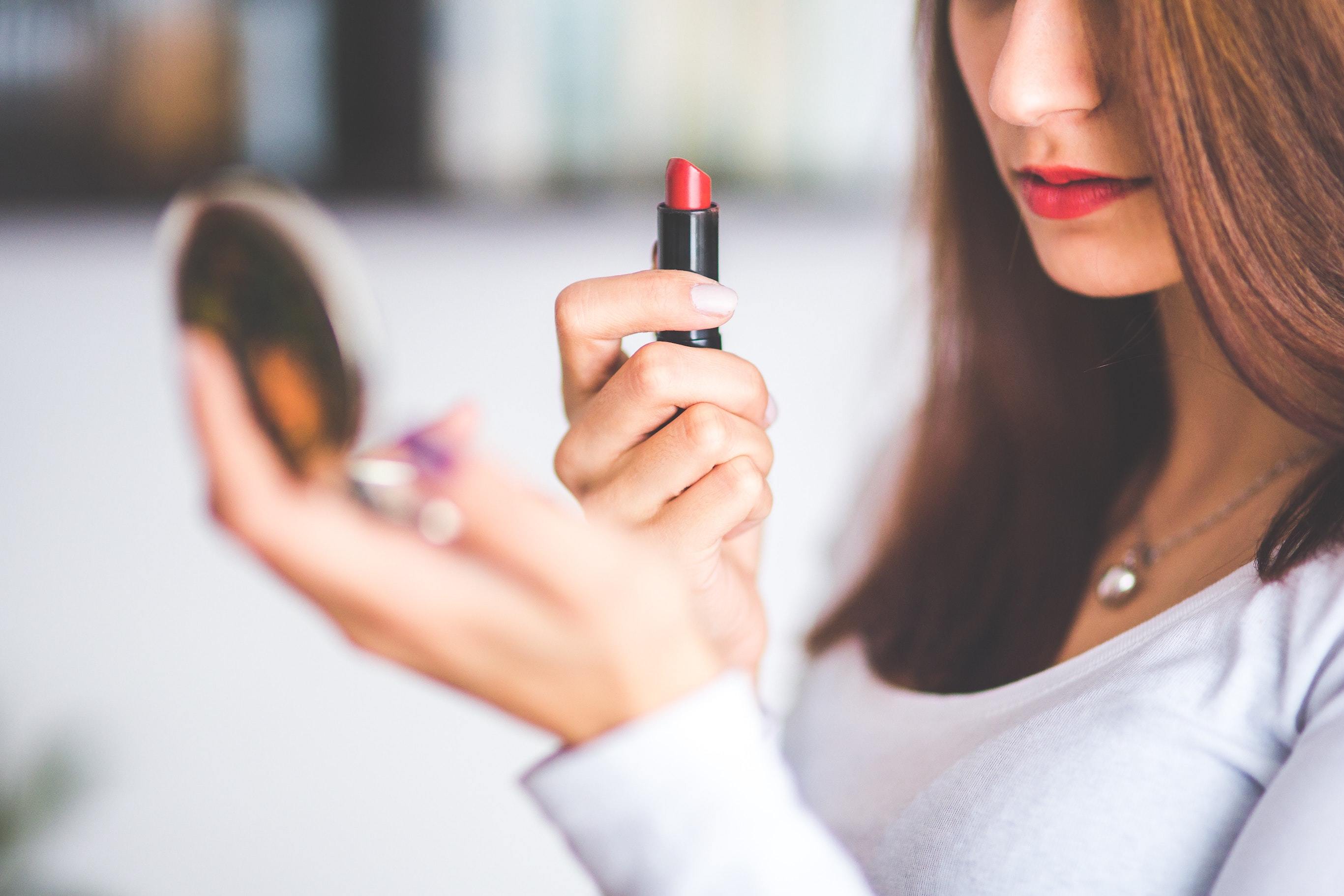 Woman applying lipstick