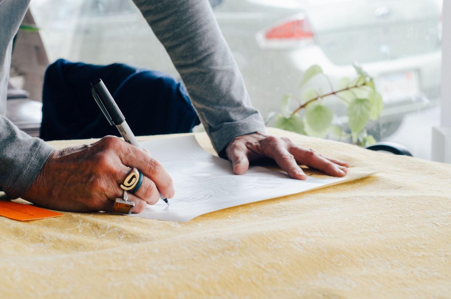 A designer leans over a table