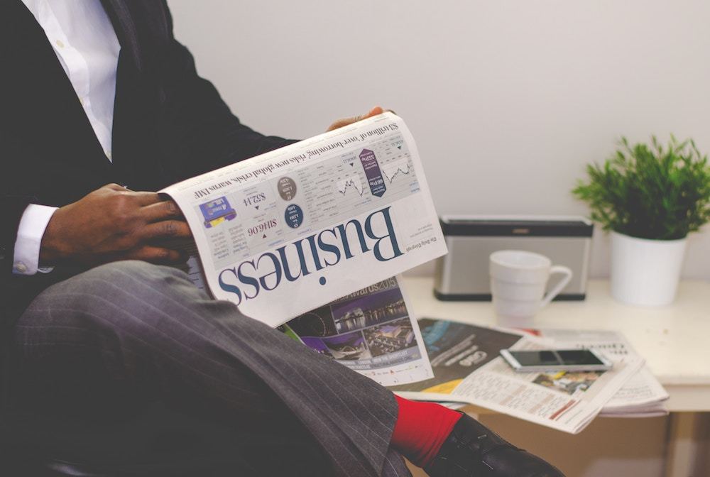 Man reading business section of newspaper