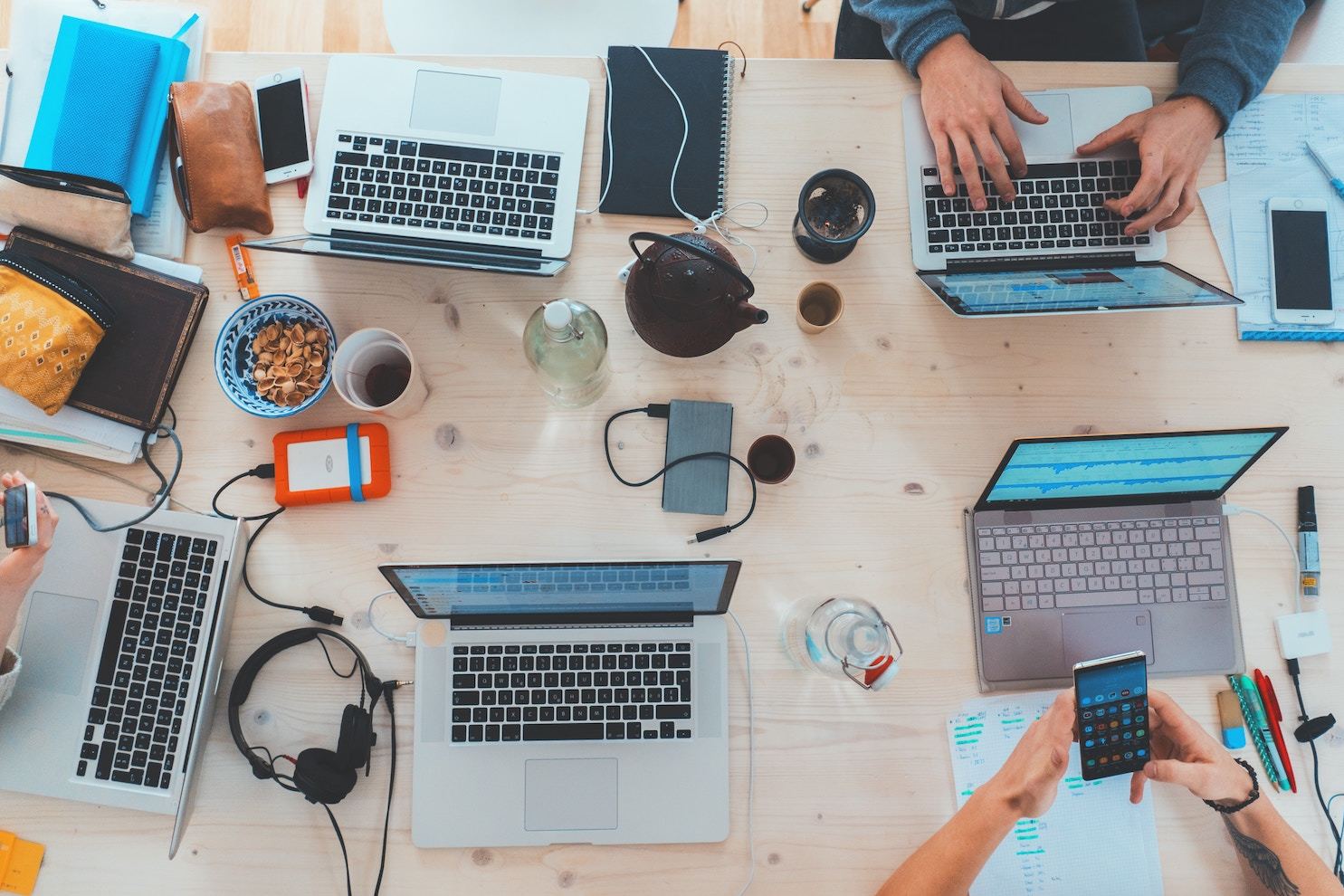 Flat lay of a group of people working on computers