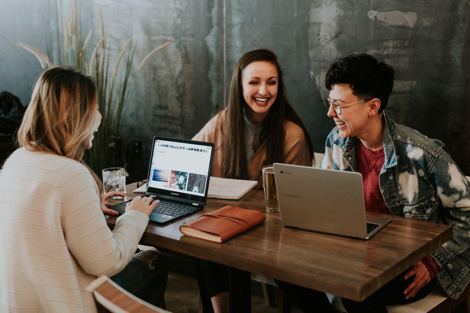 Three woman working with laptops at a table