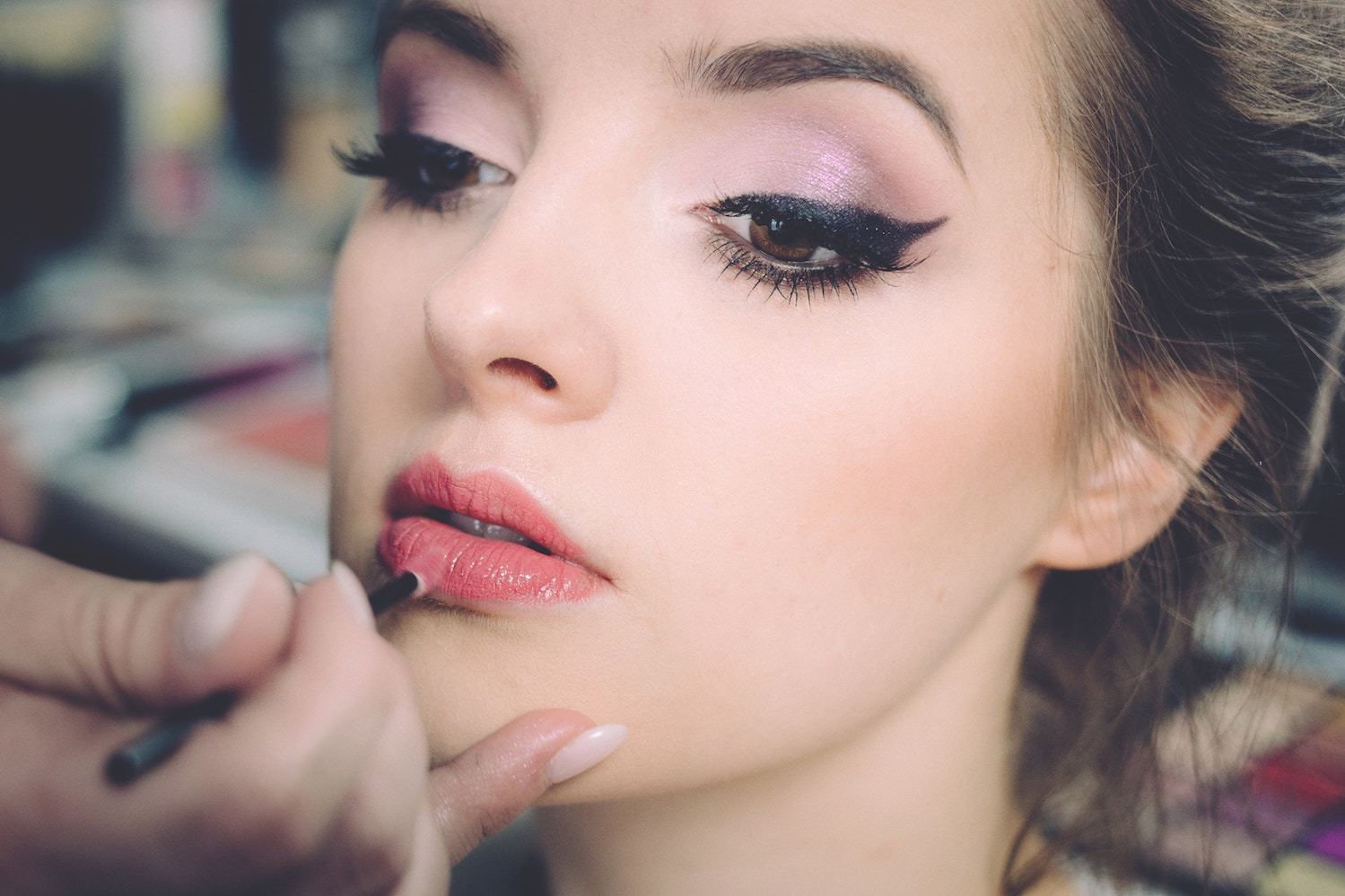 a woman having her makeup professionally done