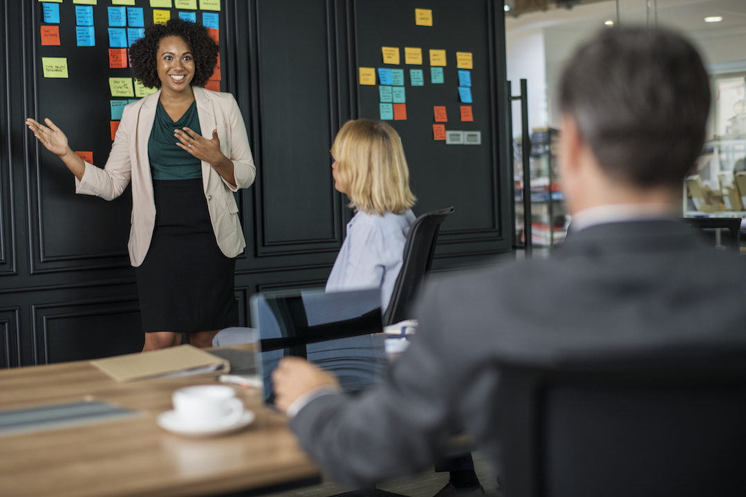 A UX designer gives a presentation to her team