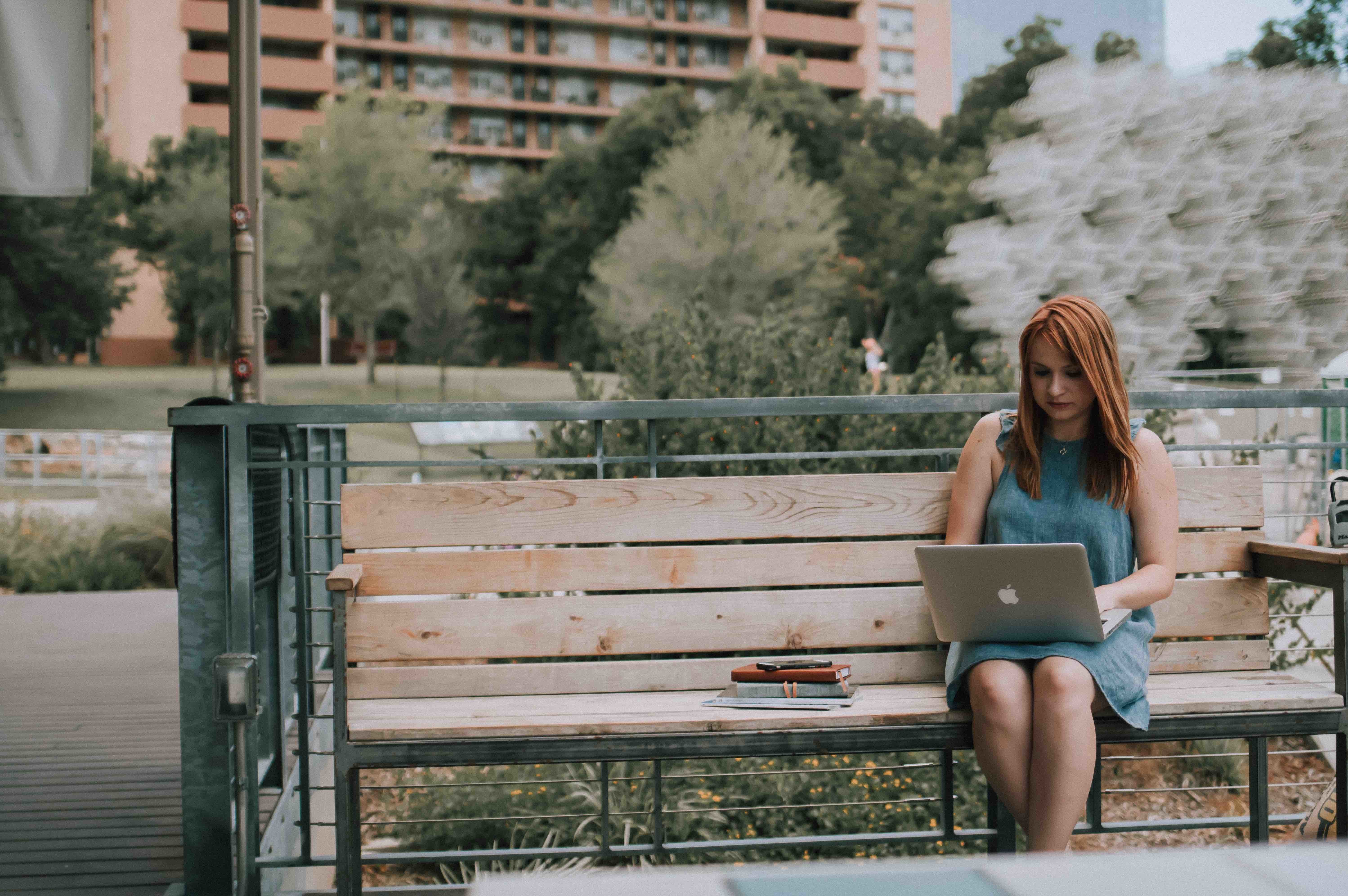 woman writing on bench