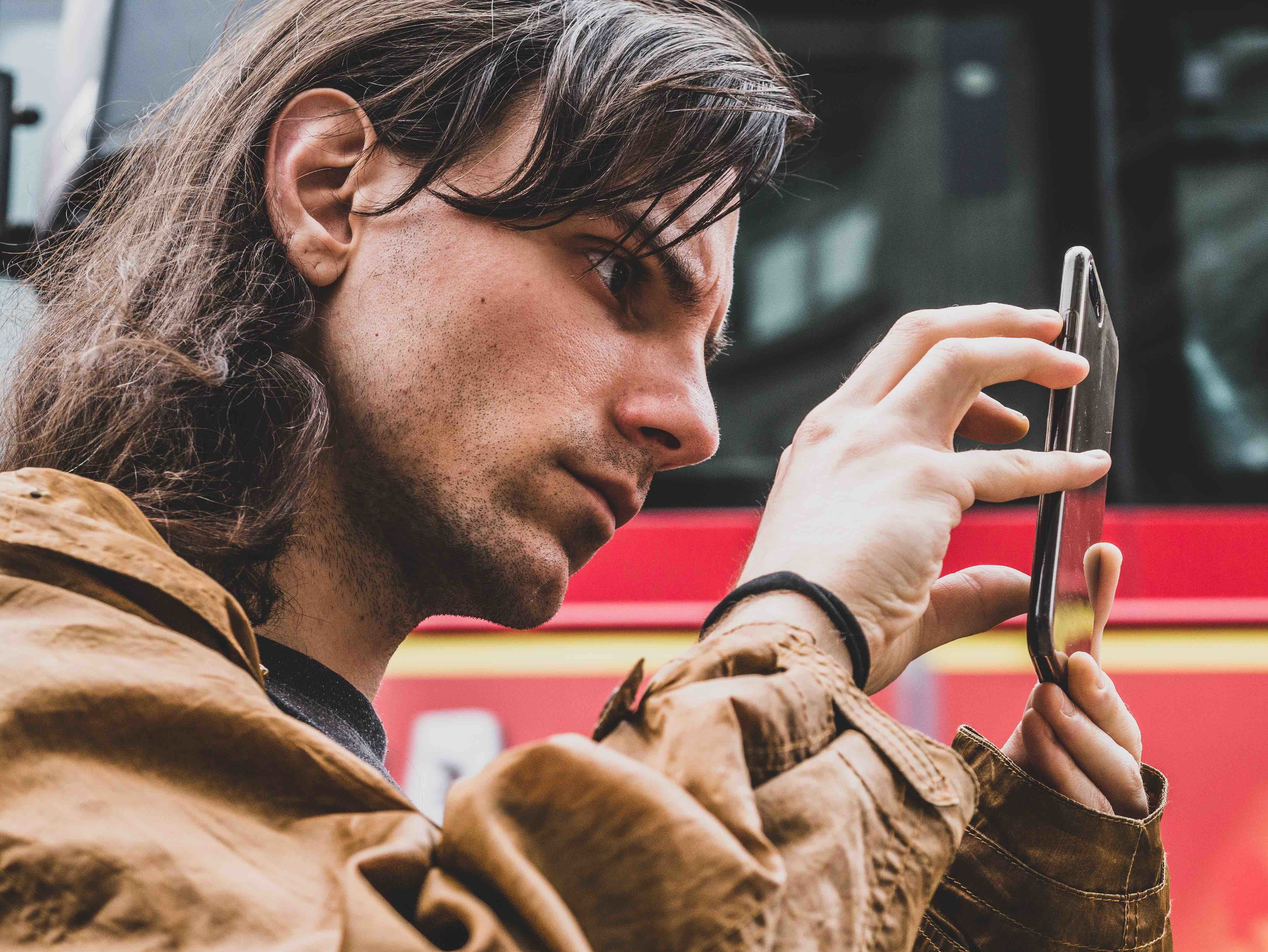 man staring at phone