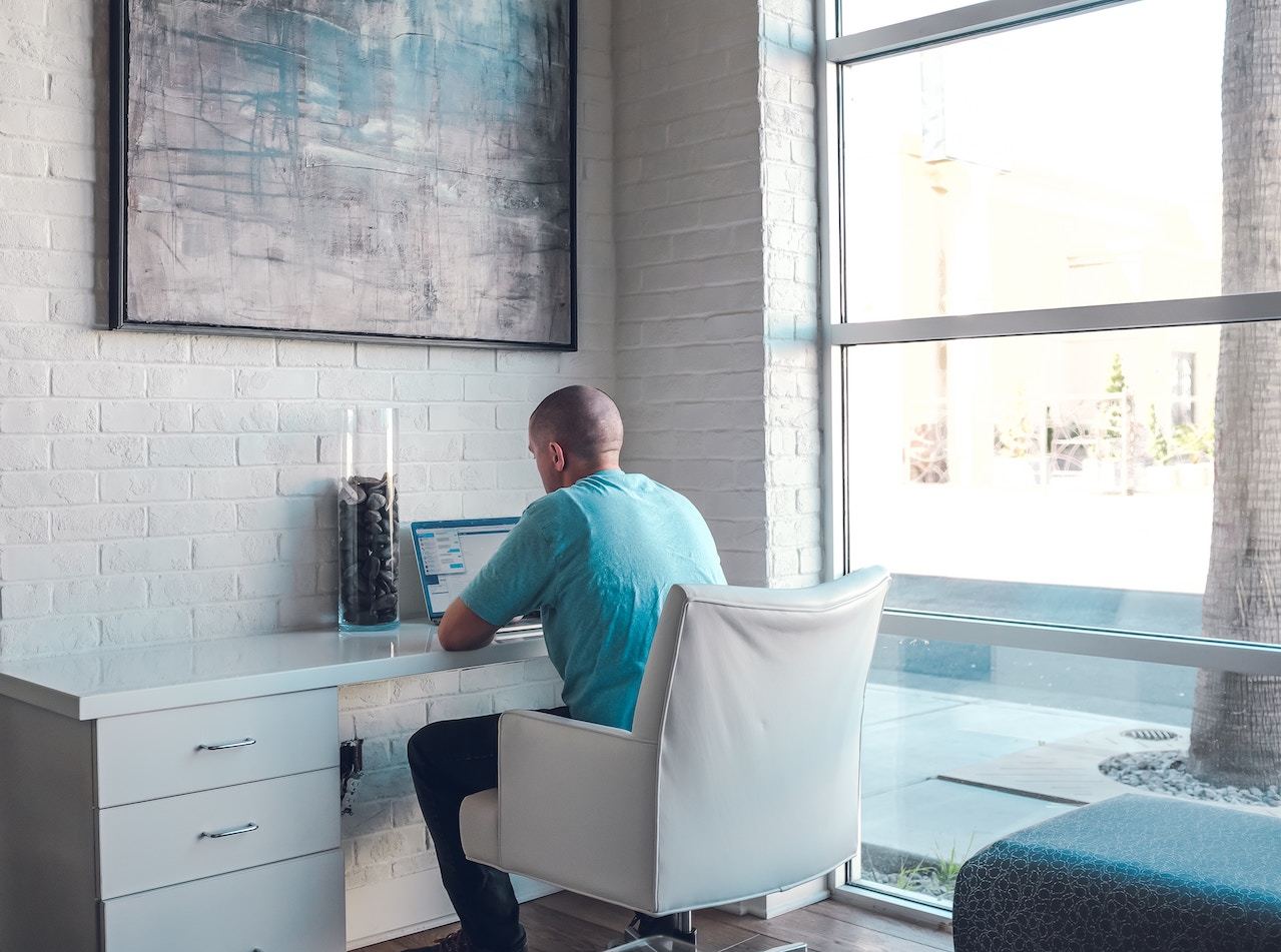 seasonality man sitting down at desk with computer