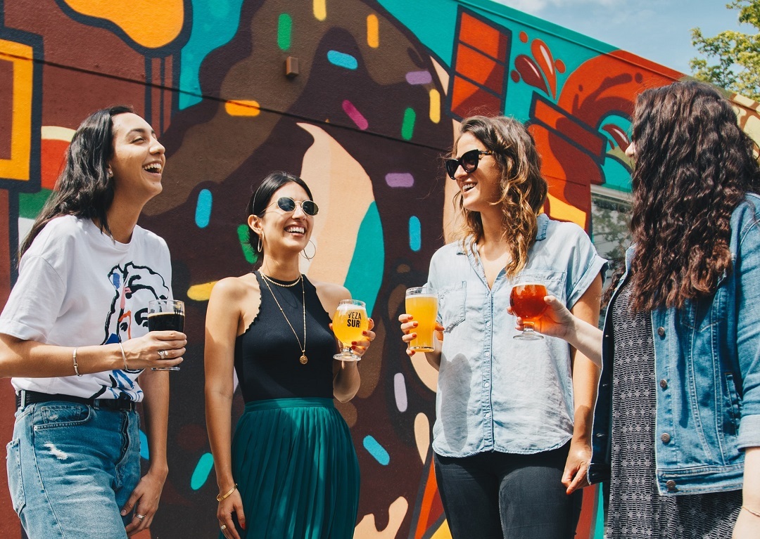 Group of millennial friends drinking beer