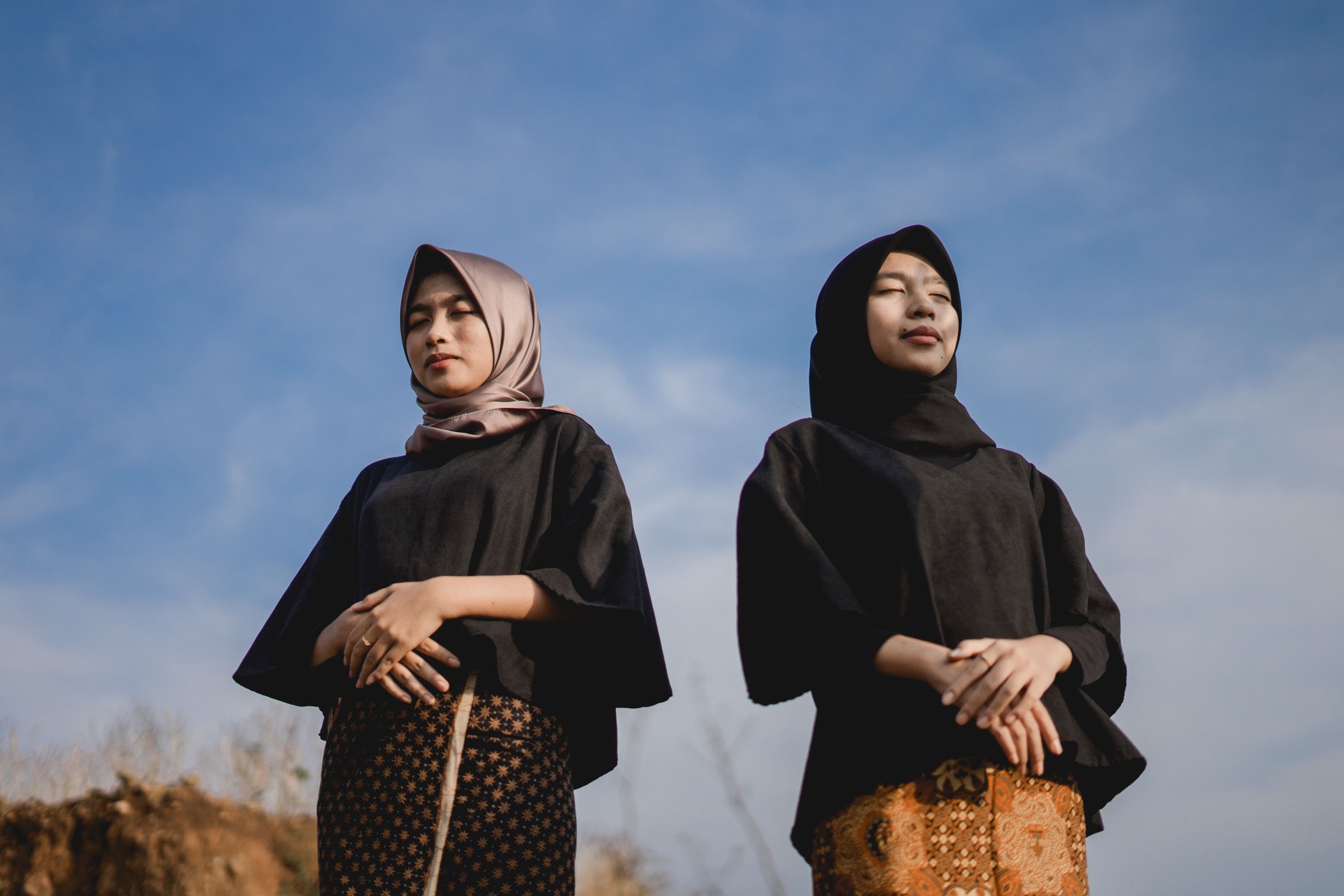 Two Muslim ladies with eyes closed
