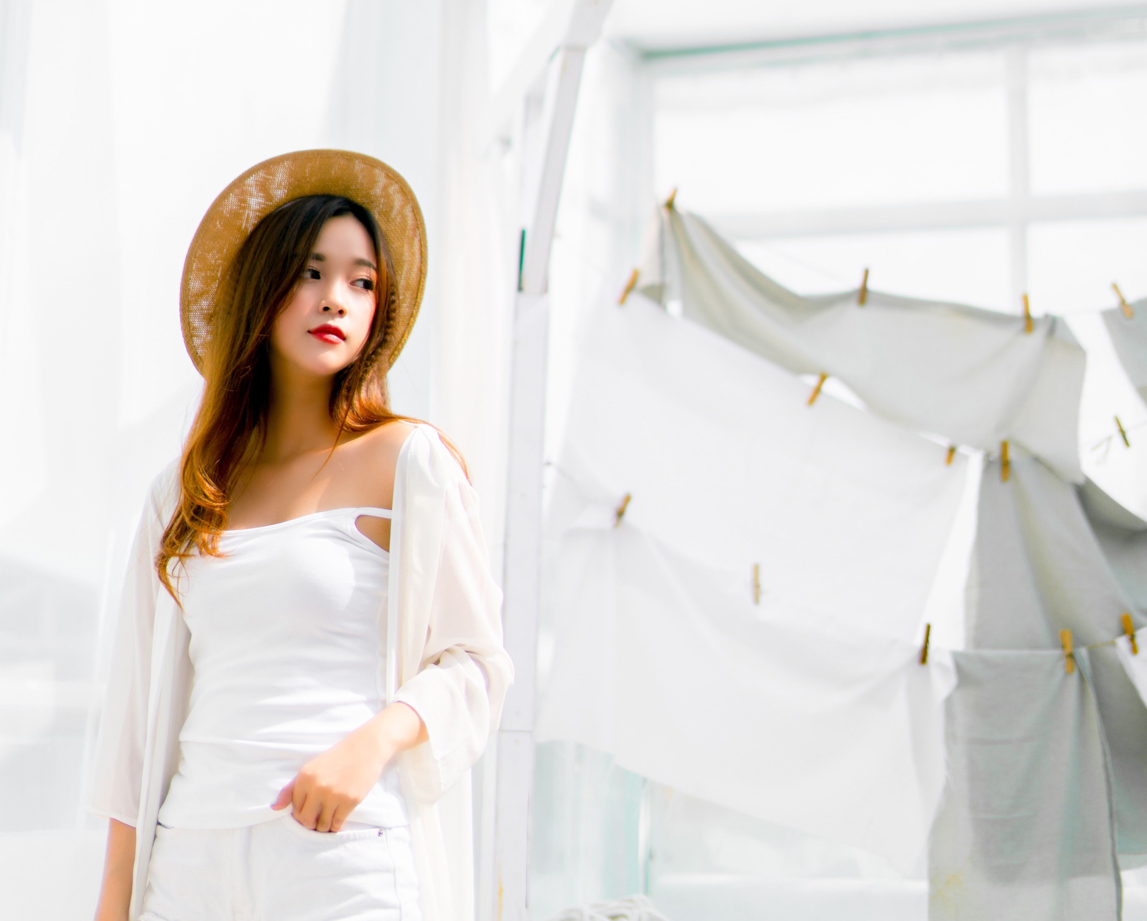 Asian girl dressed in white, on white background