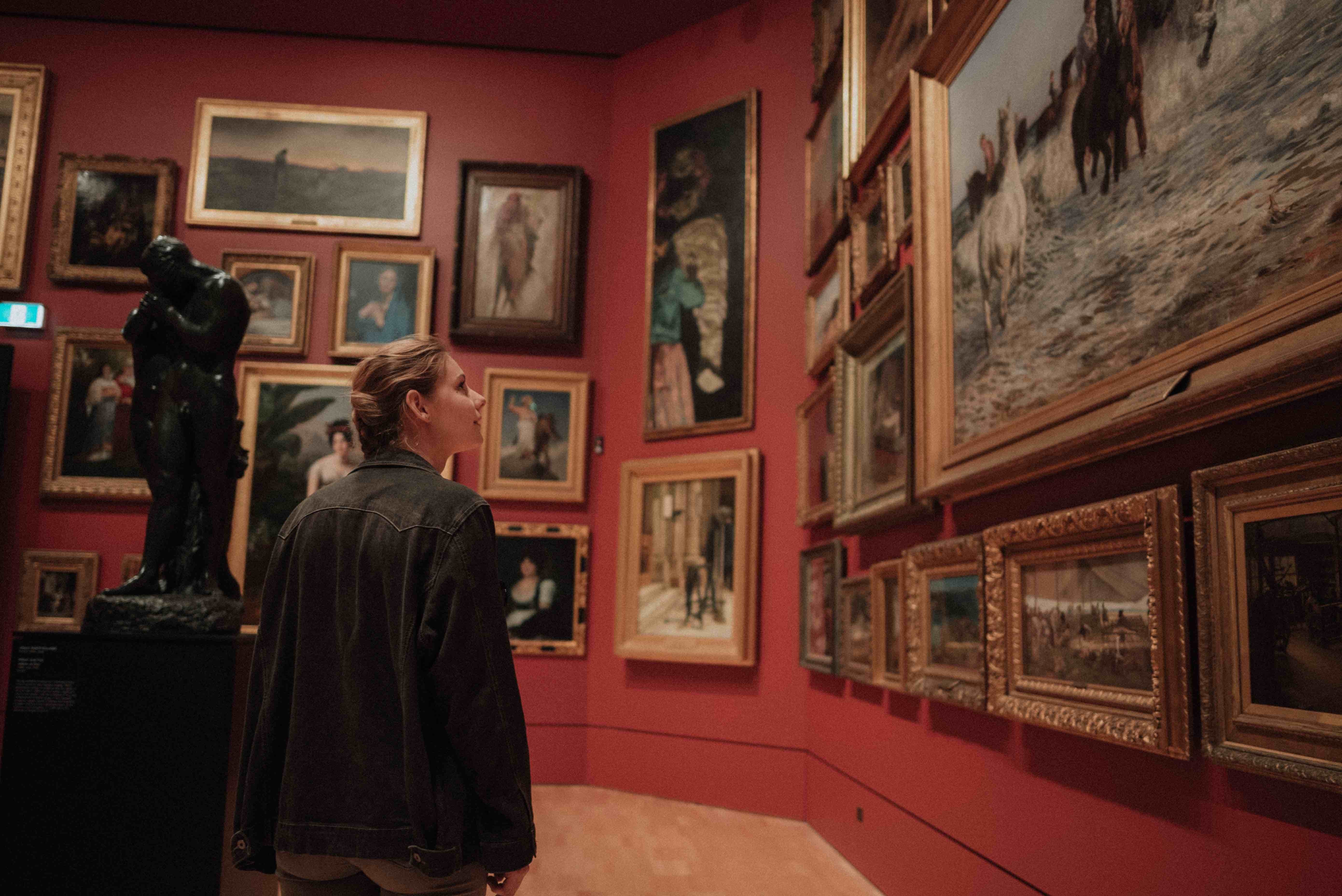 woman looking at pictures in a museum