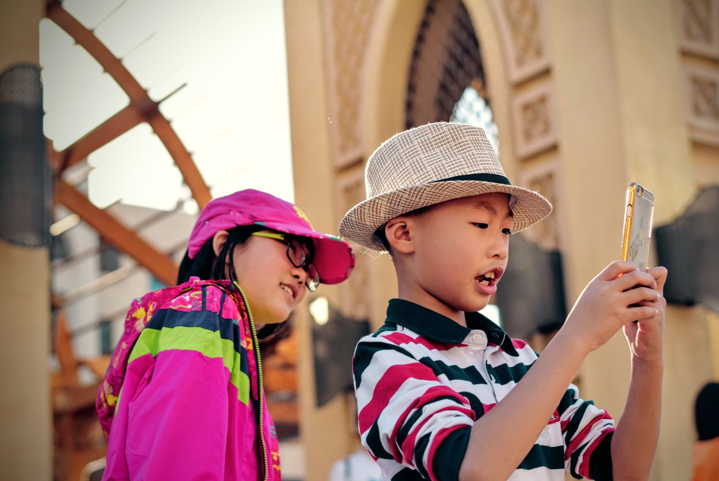 Two Chinese children using a smartphone