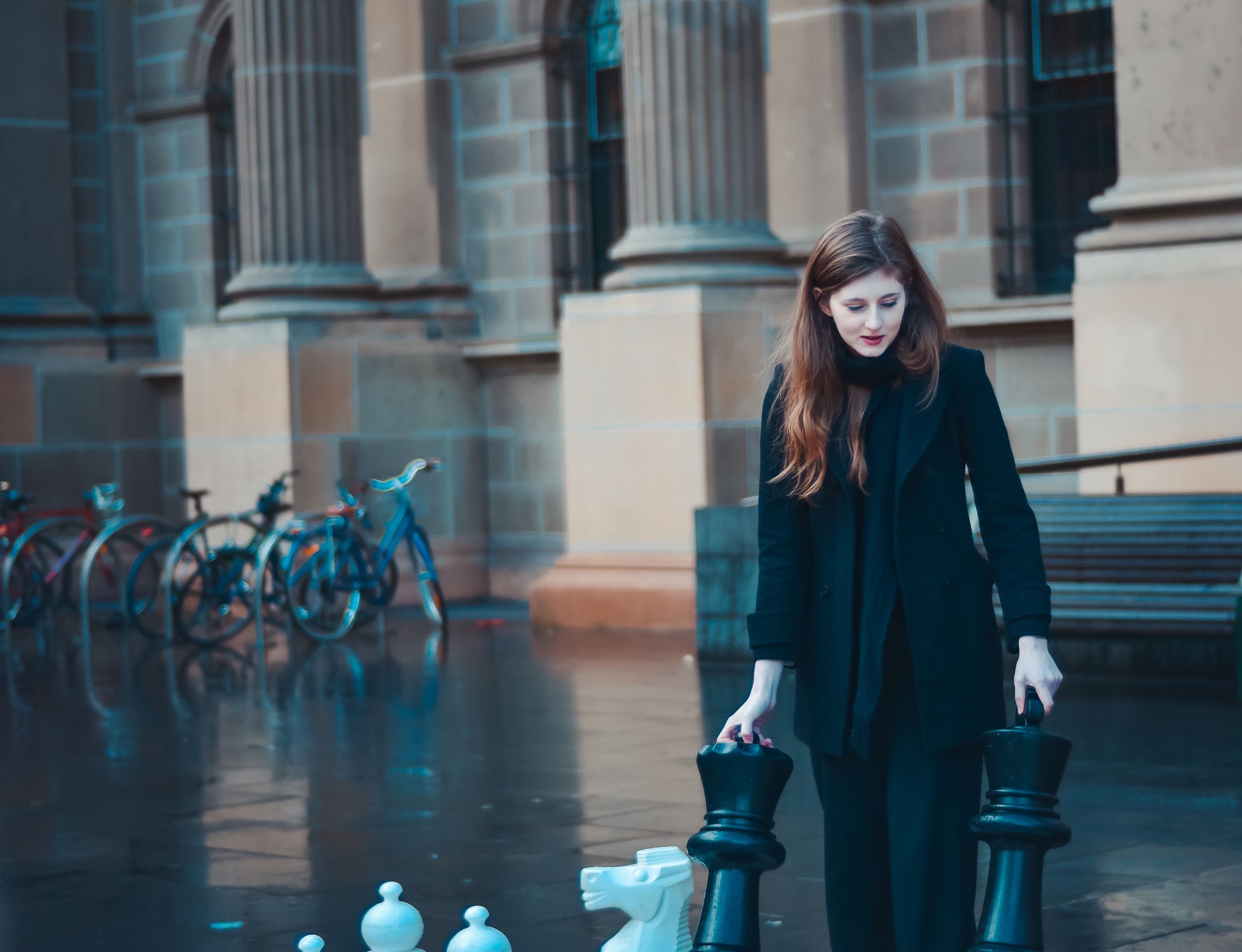 Woman with giant chess pieces