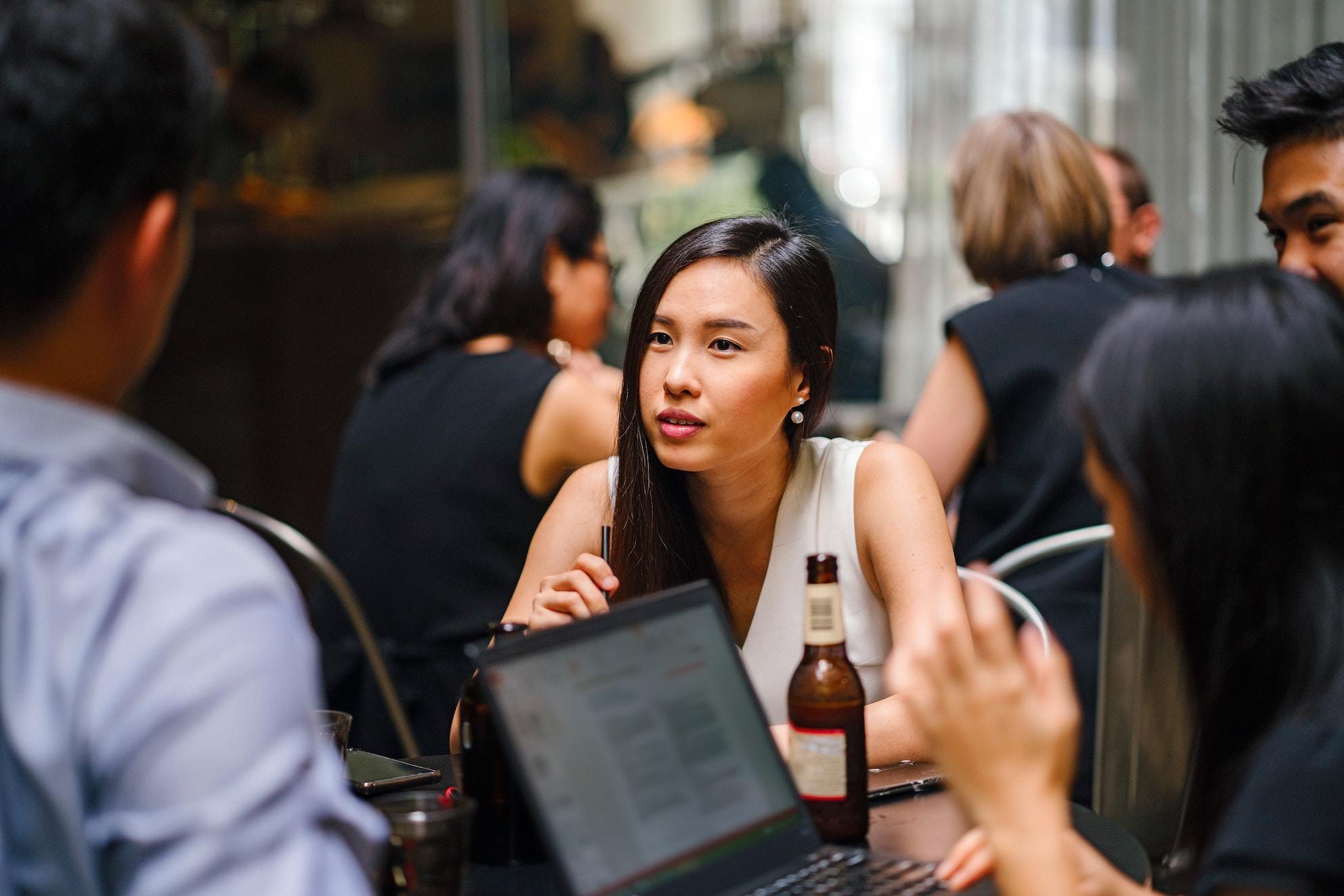 Group of colleagues at a bar with a laptop