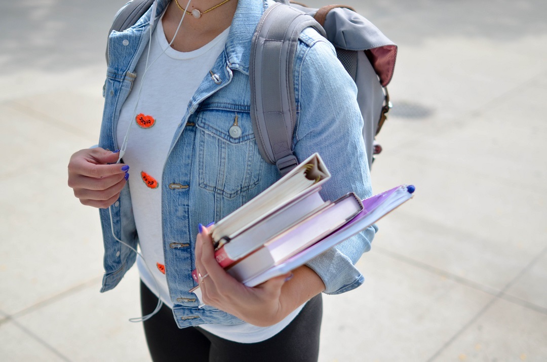 Image of a college student holding books