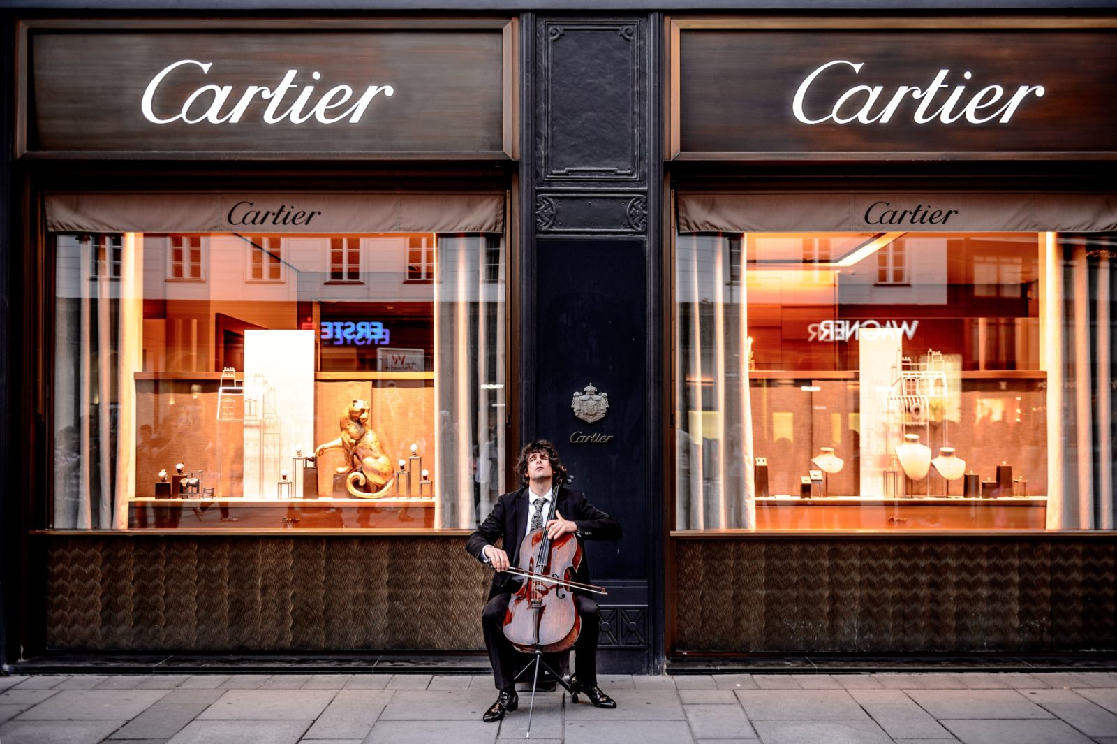 A man plays a bass violin outside a Cartier store in Vienna.
