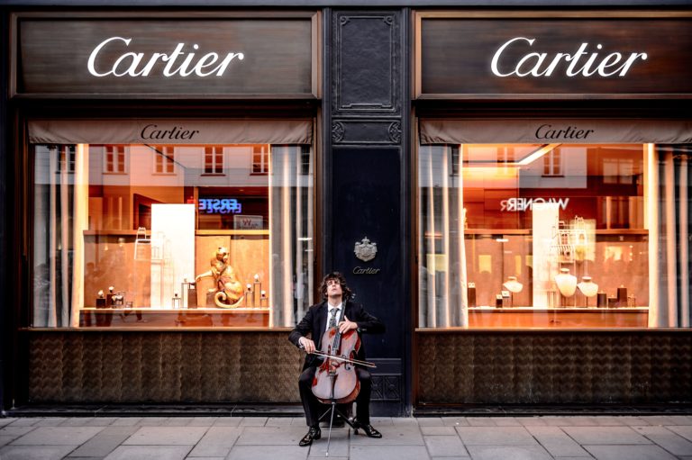 A man plays a bass violin outside a Cartier store in Vienna.