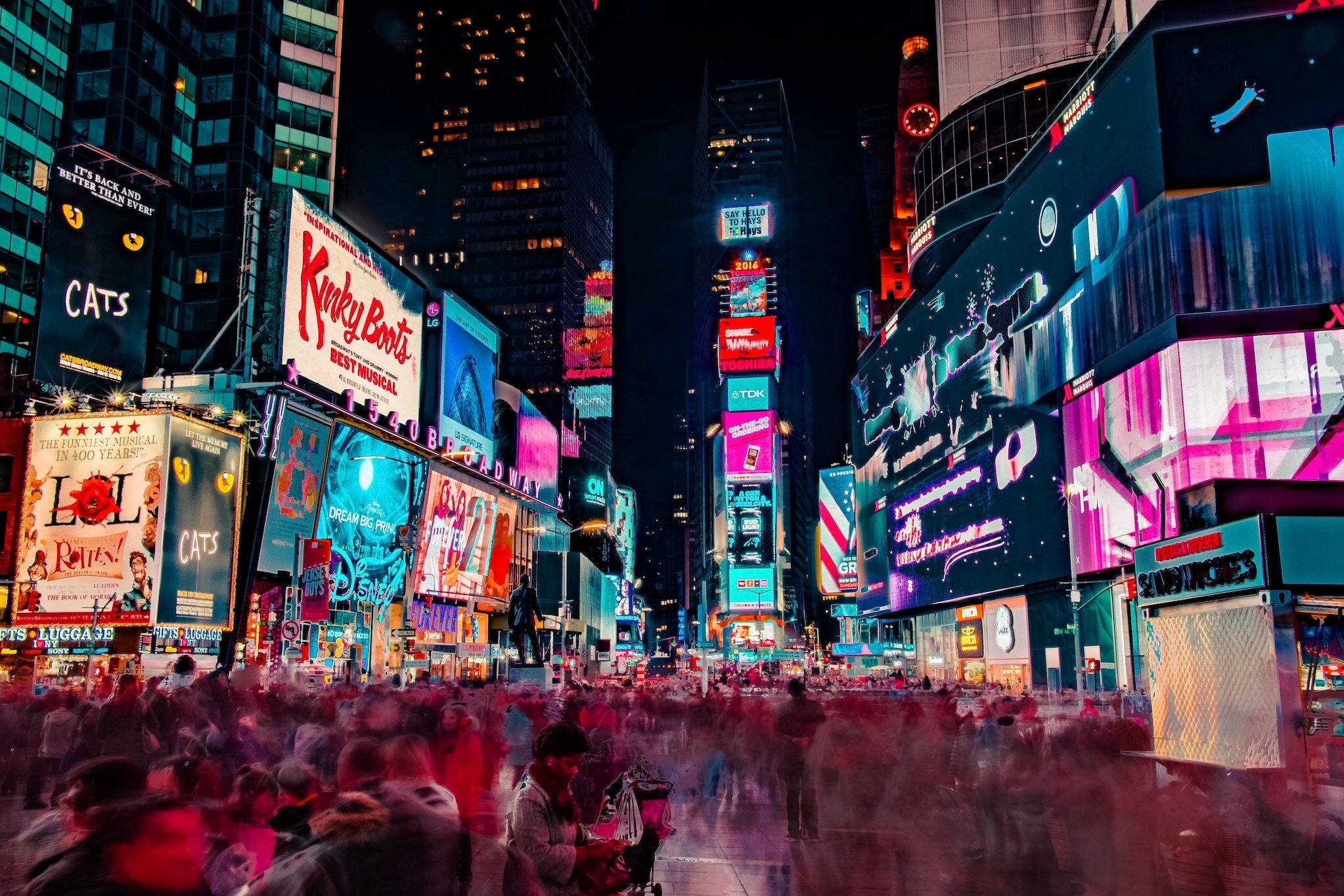 People in Times Square, New York, with neon advertising