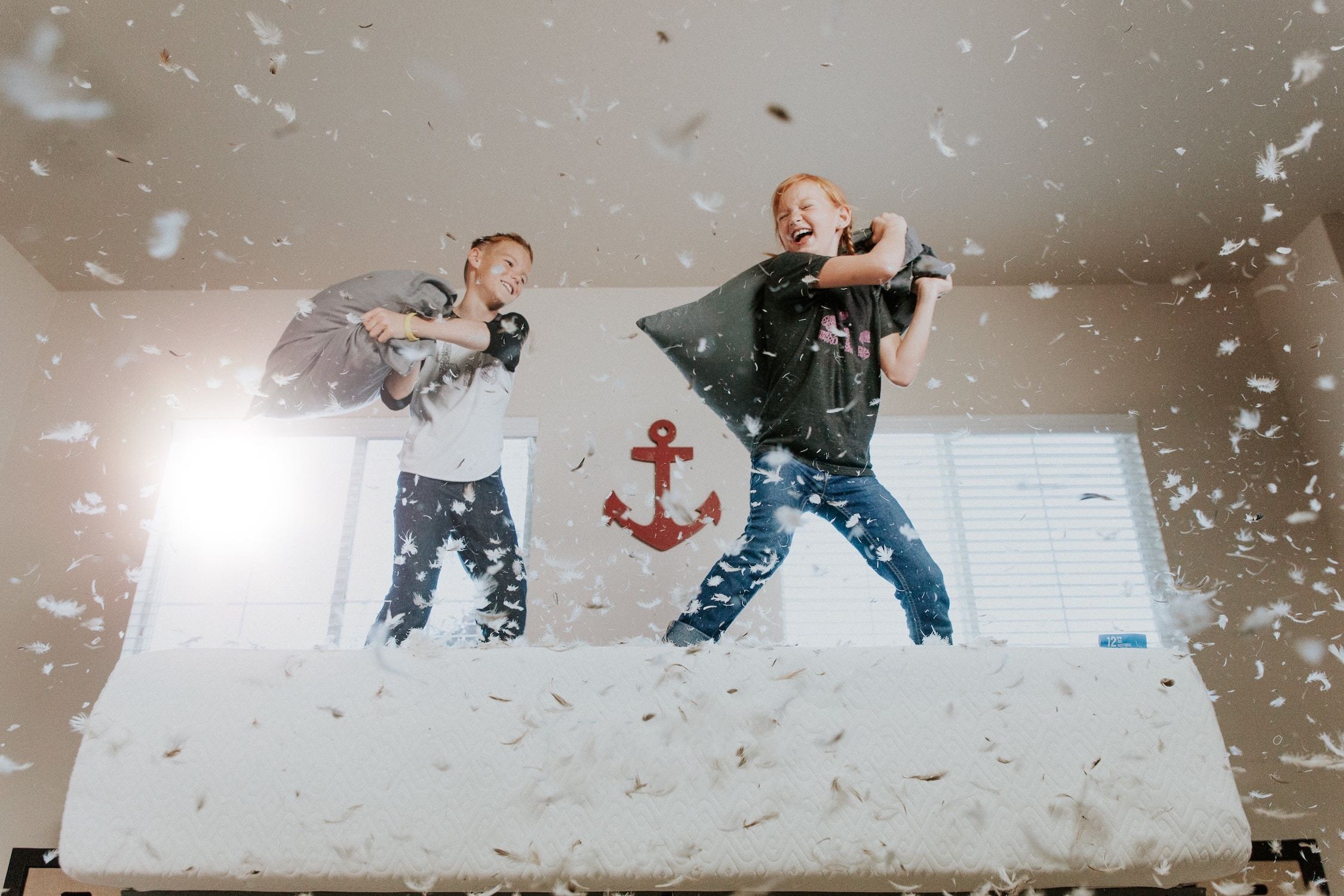 Two children having a pillow fight