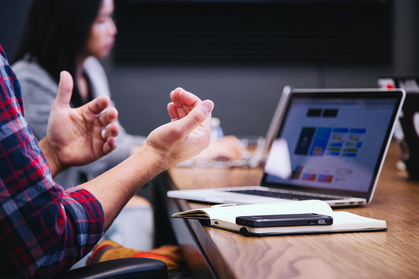 businessman sits at table discussing financial services marketing