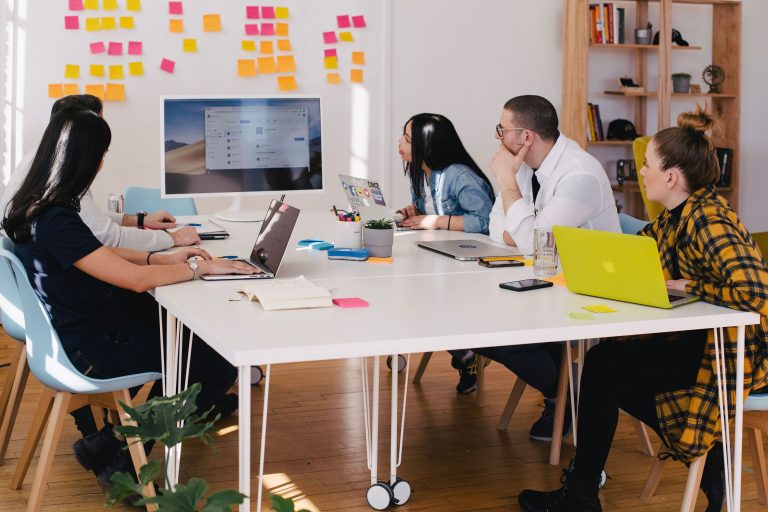 A group works on their B2B marketing campaigns for 2020 in a boardroom.