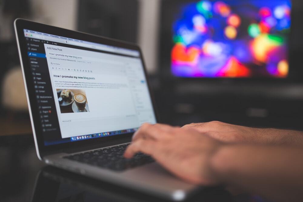 Person types an accessible content marketing blog on a laptop computer.