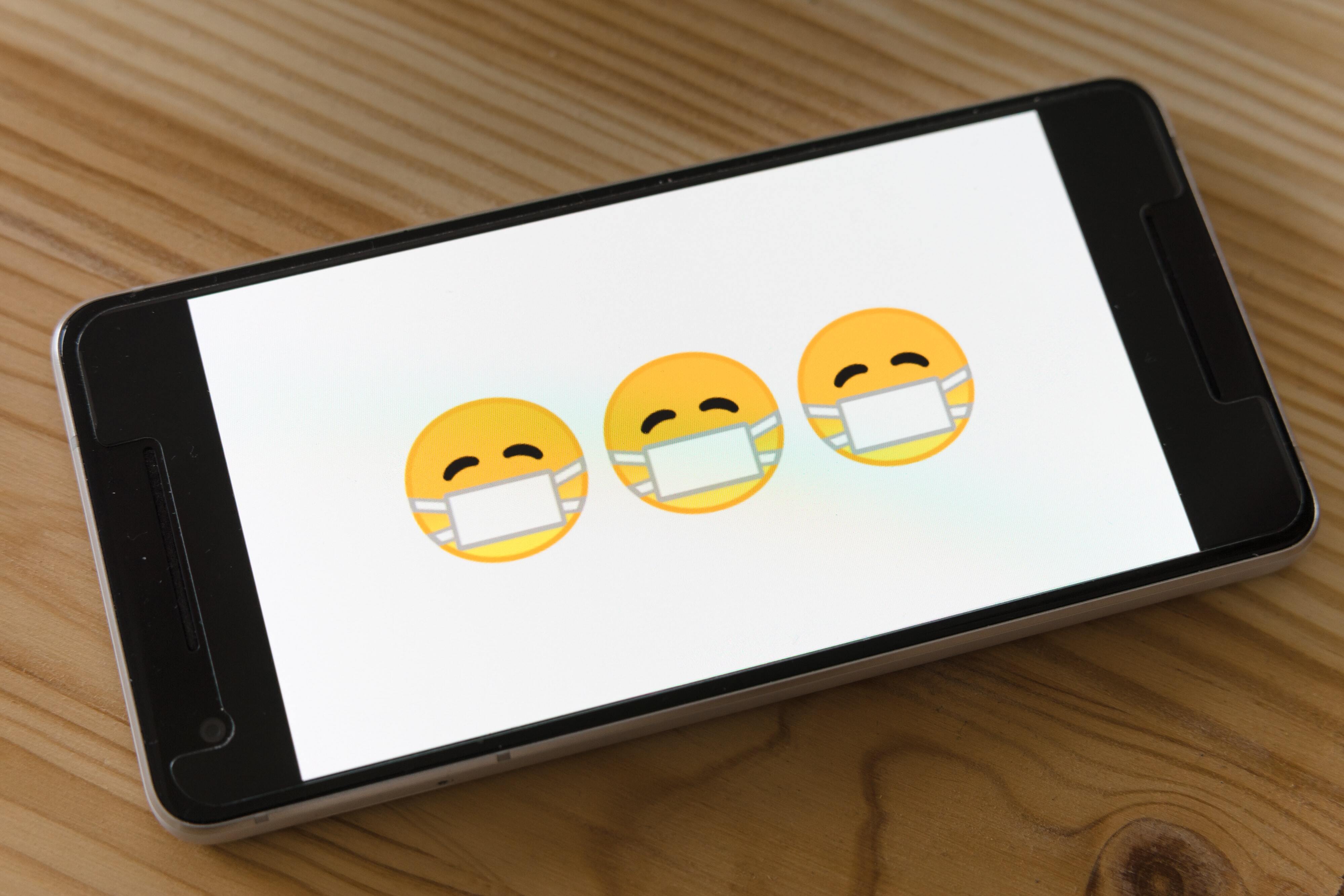 Phone with mask emojis