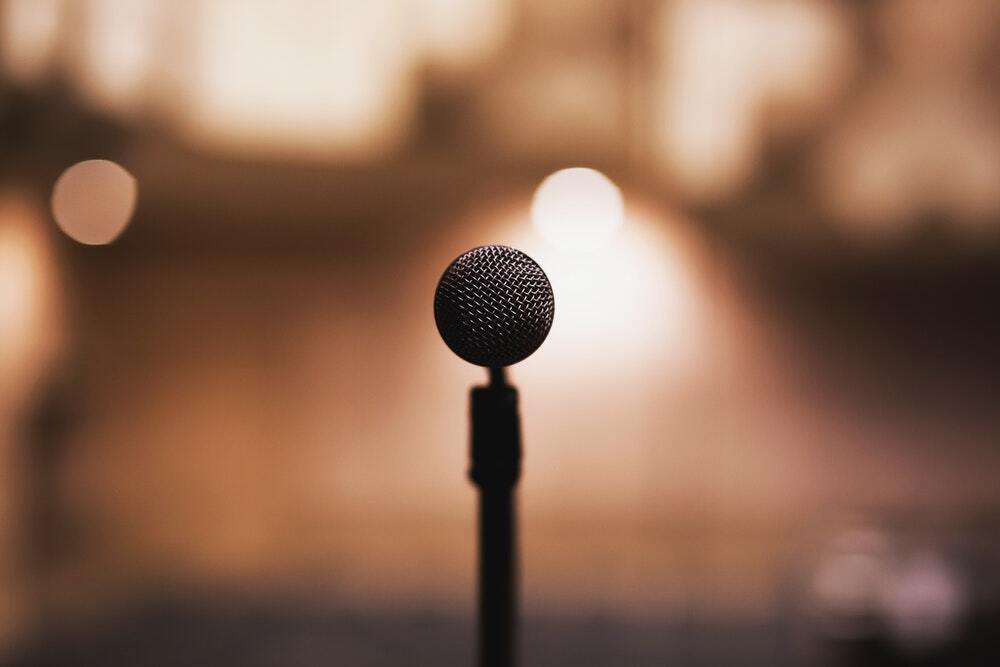 A microphone surrounded by a hazy, warmly lit background.