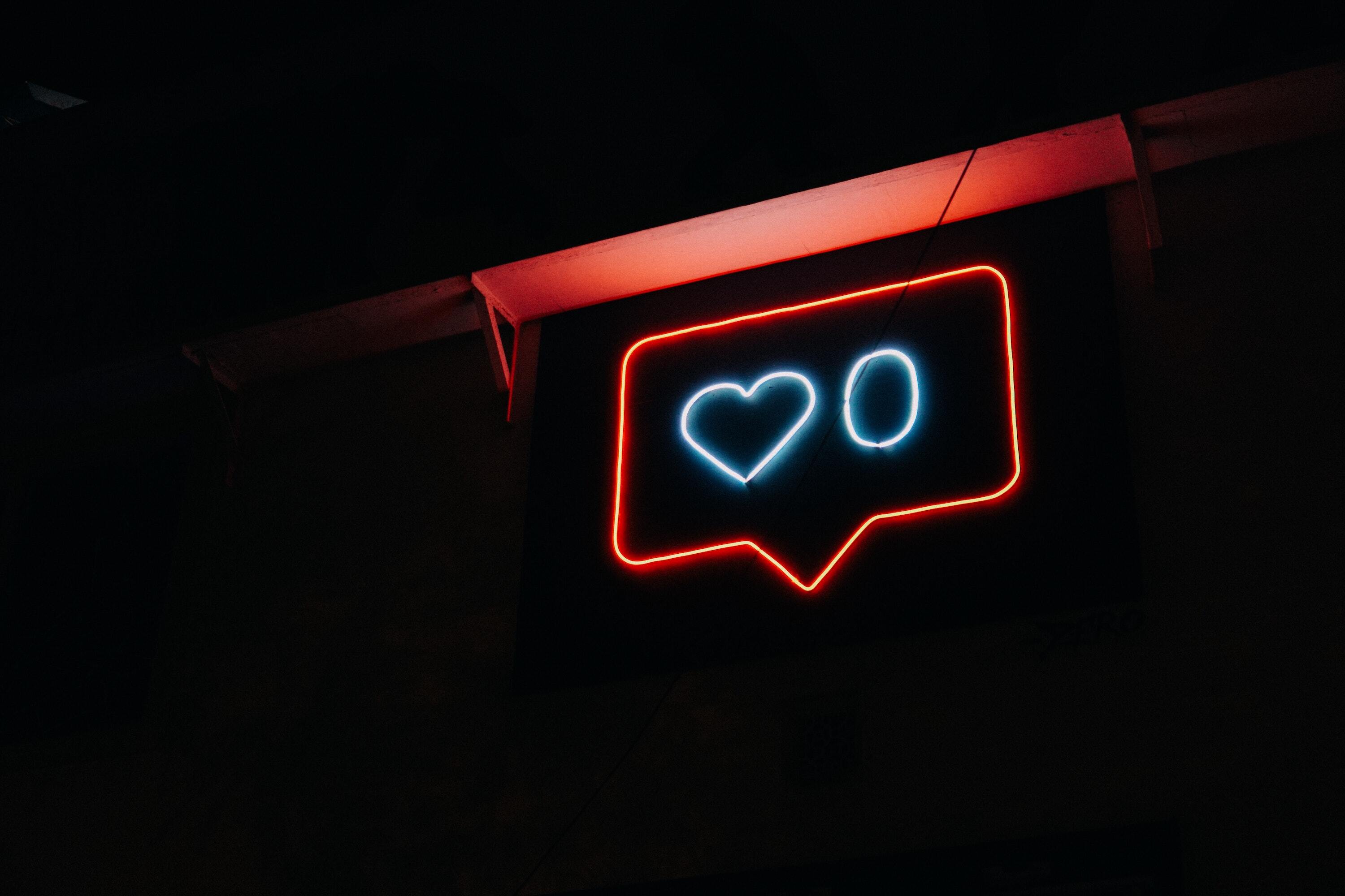 Neon sign featuring Instagram like symbol